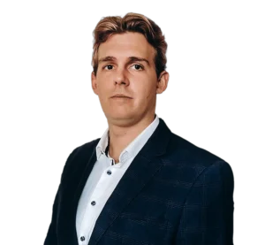 Portrait of Dávid Dobos, business consultant in a navy checked suit and white shirt